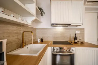 a kitchen with a sink and a stove at Lithinon Luxury Suites with Free Parking in Chania Town