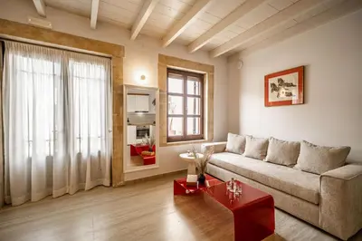 a living room with a couch and a table at Lithinon Luxury Suites with Free Parking in Chania Town