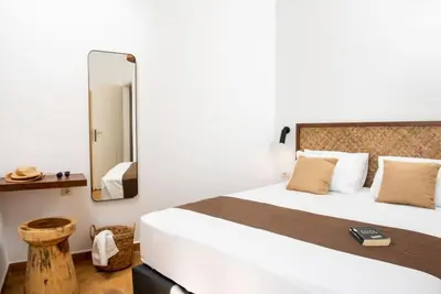 a bedroom with a large bed and a mirror at Villa Tramonto - Falasarna in Falasarna