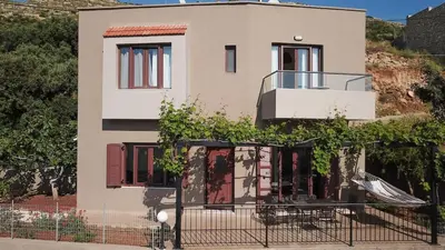 a house with a slide in front of it at Villa Tramonto - Falasarna in Falasarna