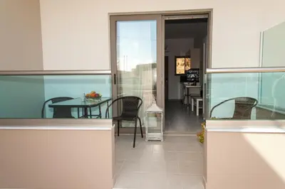 a dining room with a table and chairs in a building at Efrilias Studios & Apartments in Kissamos