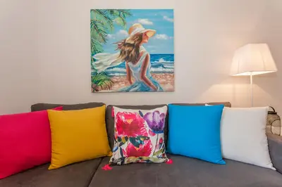 a bunch of colorful pillows sitting on a couch at Mary Suites Chania in Chania Town
