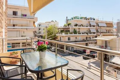 a balcony with a table with flowers on it at Mary Suites Chania in Chania Town