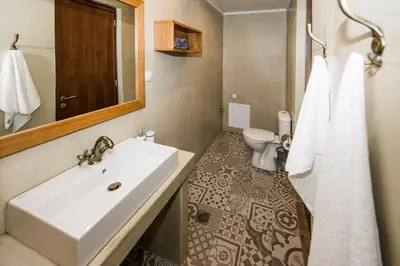 a bathroom with a sink and a toilet at Lardas Luxury Country House in Kissamos