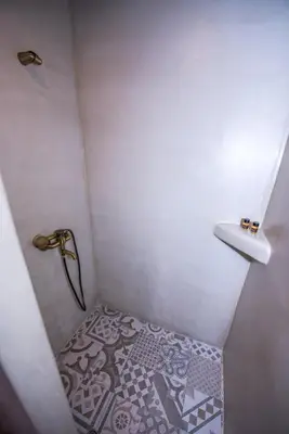 a small bathroom with a shower and a sink at Lardas Luxury Country House in Kissamos