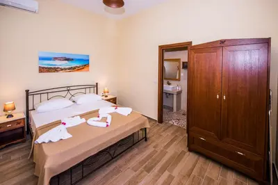 a bedroom with a bed with two swans on it at Lardas Luxury Country House in Kissamos