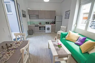 a living room with a green couch and a table at Mare Civitas Apartments in Chania Town