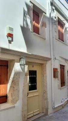 a building with a yellow door and a window at Casa Eleni in Chania Town