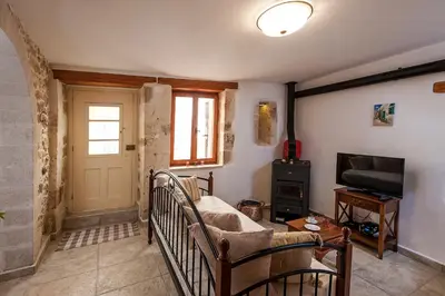 a living room with a couch and a television at Casa Eleni in Chania Town