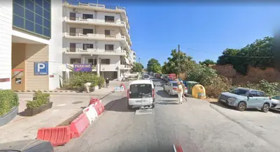 a street with cars parked on the side of a building at Stefan's City Hub in Chania Town