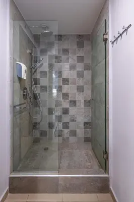 a bathroom with a shower with a glass door at Stefan's City Hub in Chania Town