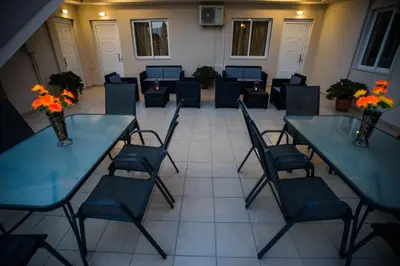 a room with tables and chairs with flowers on them at Naiades Luxury Apartments in Kalathas