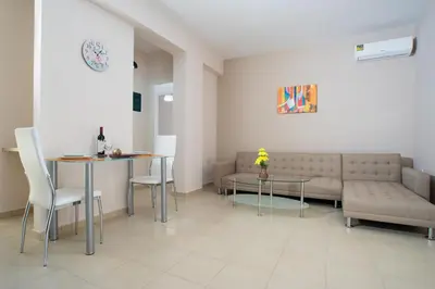 a living room with a couch and a table at Naiades Luxury Apartments in Kalathas