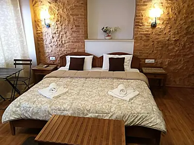 a hotel room with a bed with towels on it at Santrivani Rooms in Chania Town