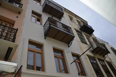 a building with windows and balconies on it at Santrivani Rooms in Chania Town