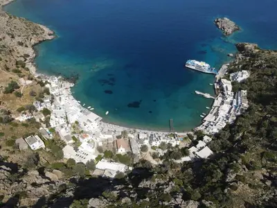 an aerial view of a harbor with a boat in the water at Loutro Holidays in Loutro