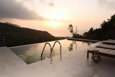 a swimming pool with a view of the ocean at Villa Levande in Sfinárion