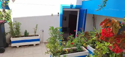 a room with some plants and a door with flowers at Blue Sky in Palaiochóra