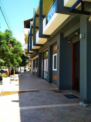 a building with blue and white walls and a sidewalk at Beloni Apartments and Studios in Chania Town