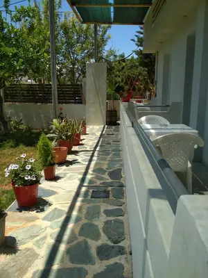 a walkway with potted plants on a house at Beloni Apartments and Studios in Chania Town