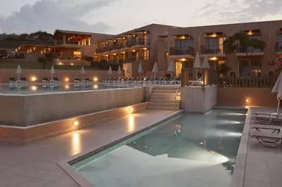 a hotel with a swimming pool in front of a building at Giannoulis – Santa Marina Beach Hotel in Agia Marina Nea Kydonias