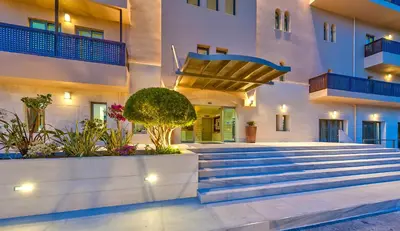 a courtyard of a building with stairs and plants at Giannoulis – Santa Marina Beach Hotel in Agia Marina Nea Kydonias