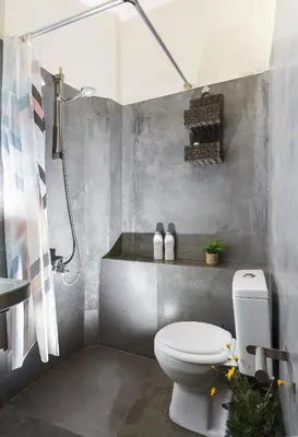a bathroom with a white toilet and a shower at Kd's - Apartment in Chania Town