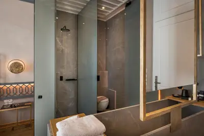 a bathroom with a toilet and a mirror at Scala de Faro in Chania Town