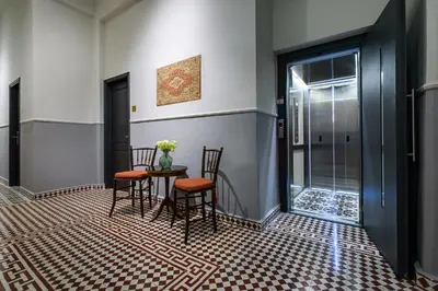 a dining room with two chairs and a table with flowers at Mosaic in Chania Town