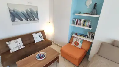 a living room with a couch and a chair at Blue Villas in Agia Marina Nea Kydonias