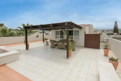 a patio with a gazebo on top of a house at Talos Hotel Apartments in Kato Daratso