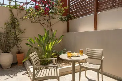 a table and chairs with drinks on a patio at Talos Hotel Apartments in Kato Daratso