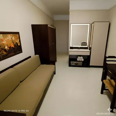 a living room with a couch and a television at Talos Hotel Apartments in Kato Daratso
