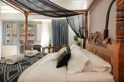 a bedroom with a large bed with a canopy at Vranas Ambiance Hotel in Chania Town