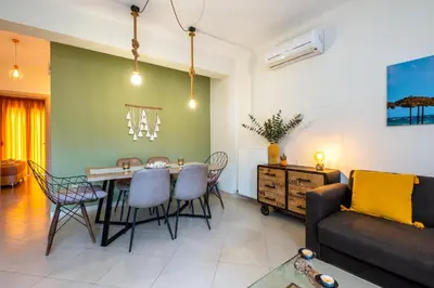 a living room with a table and chairs and a couch at Chryssi myHome in Kato Daratso
