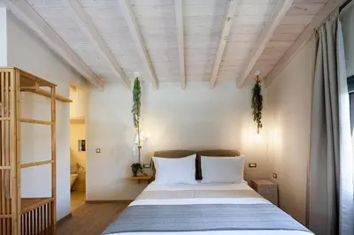 a bedroom with a large bed with white pillows at Villa Veni in Kolymvari