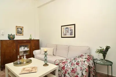 a living room with a couch and a table at Haralabos Central Apartment in Chania Town