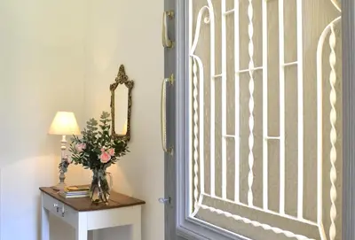 a door with a vase of flowers on a table at Haralabos Central Apartment in Chania Town