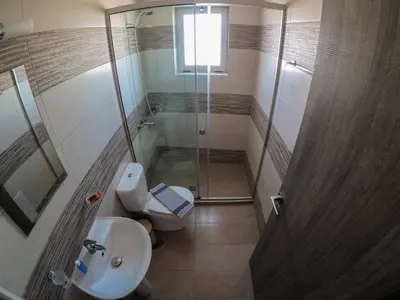 a bathroom with a shower and a toilet and a sink at Enali Villas in Kissamos