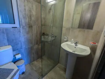 a bathroom with a shower and a sink and a toilet at Enali Villas in Kissamos