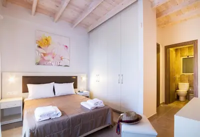 a bedroom with a bed and a toilet in a room at Enali Villas in Kissamos