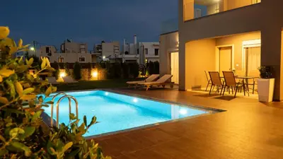 a swimming pool in the backyard of a house at Enali Villas in Kissamos