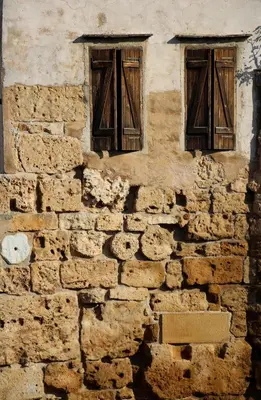 an old stone building with two windows on it at Spolia Art Maison in Chania Town