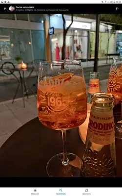 a glass of beer and a bottle on a table at TheJoy City Suites in Chania Town
