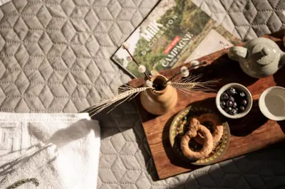 a table with a plate of food and a book at Amphitrite Hotel in Chania Town
