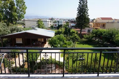 a balcony with a view of a yard at Niriis Hotel in Kato Daratso