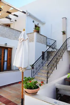 a white umbrella on a pole in front of a building at Potoula Apts in Kato Daratso