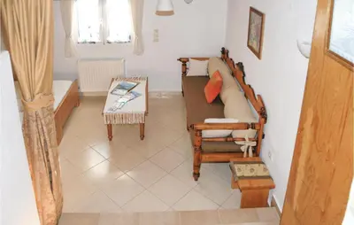 a living room with a couch and a table at Amazing Home In Malaxa, Chania in Maláxa