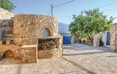 a stone building with an oven in a street at Amazing Home In Malaxa, Chania in Maláxa
