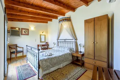 a bedroom with a bed and a wooden ceiling at Belmondo Hotel in Chania Town